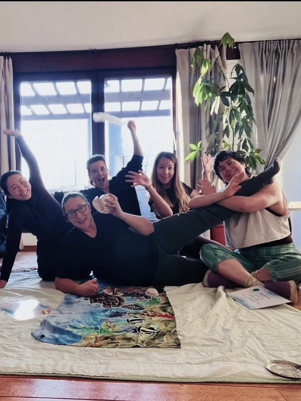The Kahuna Bodywork training group, laughing together on the studio floor at the end of the course